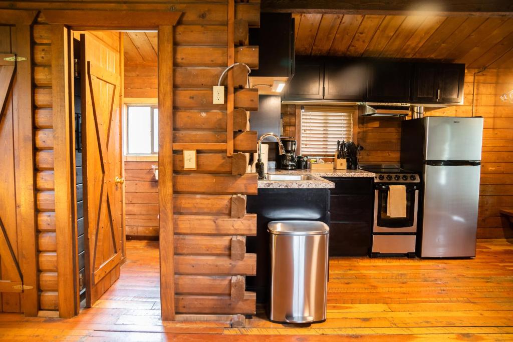 a kitchen with a refrigerator and a stove at High Creek Lodge and Cabins in Pagosa Springs