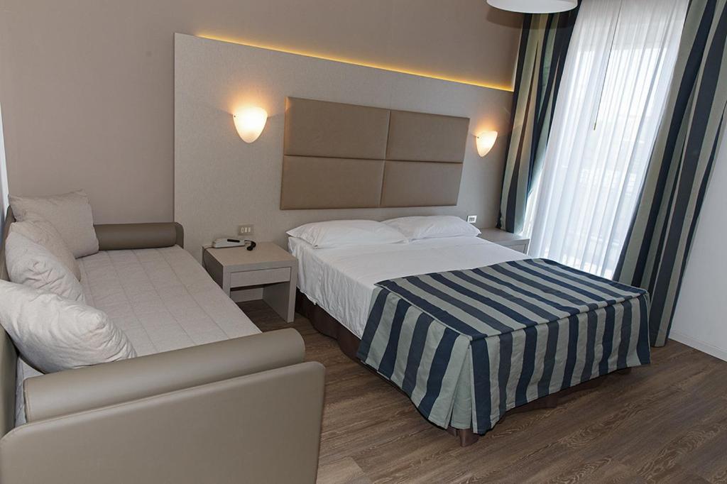 Postel nebo postele na pokoji v ubytování Hotel Sirenetta