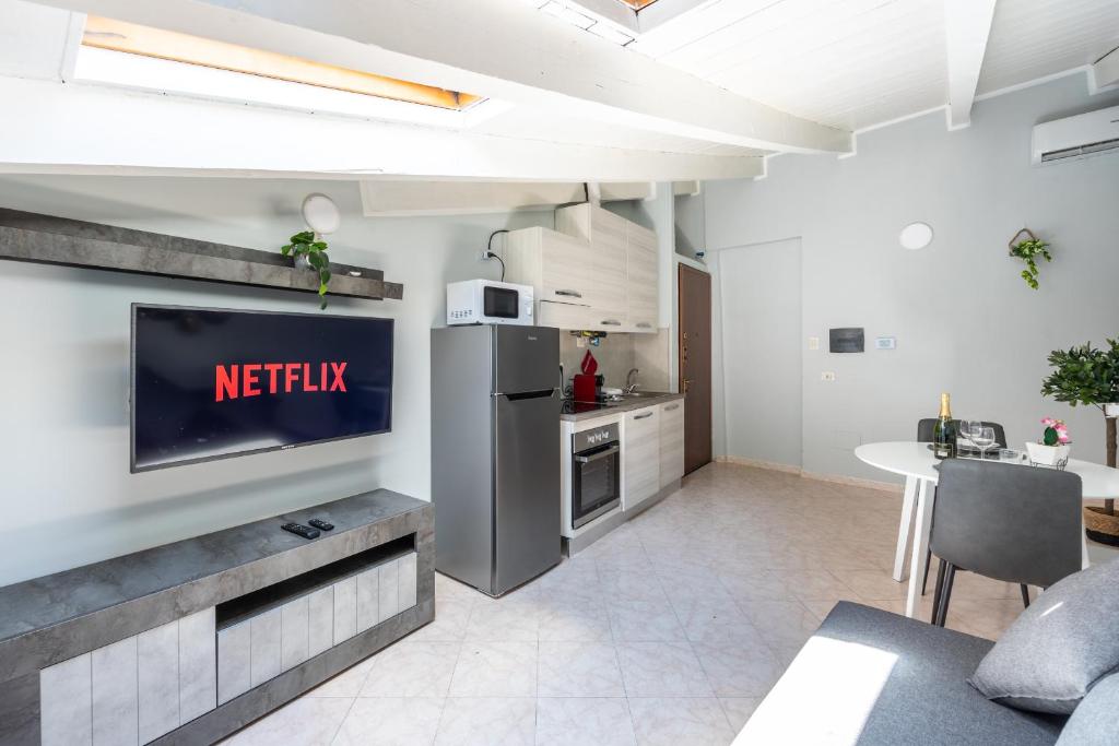 a kitchen with a refrigerator and a table in a room at Free Parking Tiny House Wifi Netflix 15 Minuti dal Duomo in Milan