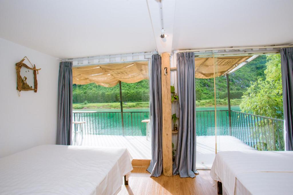 峰牙的住宿－Phong Nha A Little Leaf Homestay，一间带两张床的卧室和一个阳台