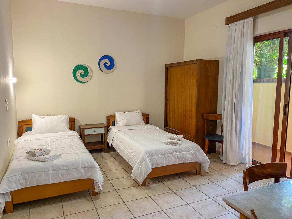 Postel nebo postele na pokoji v ubytování Ariadne Beach