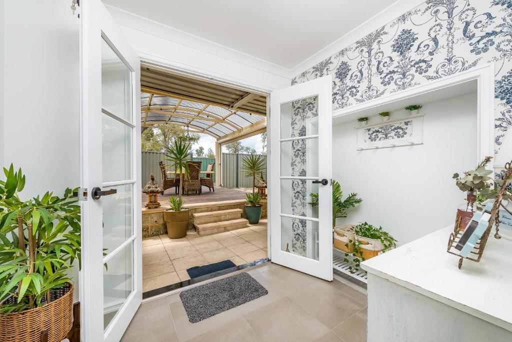 an open door to a patio with plants at Swan Valley in Upper Swan