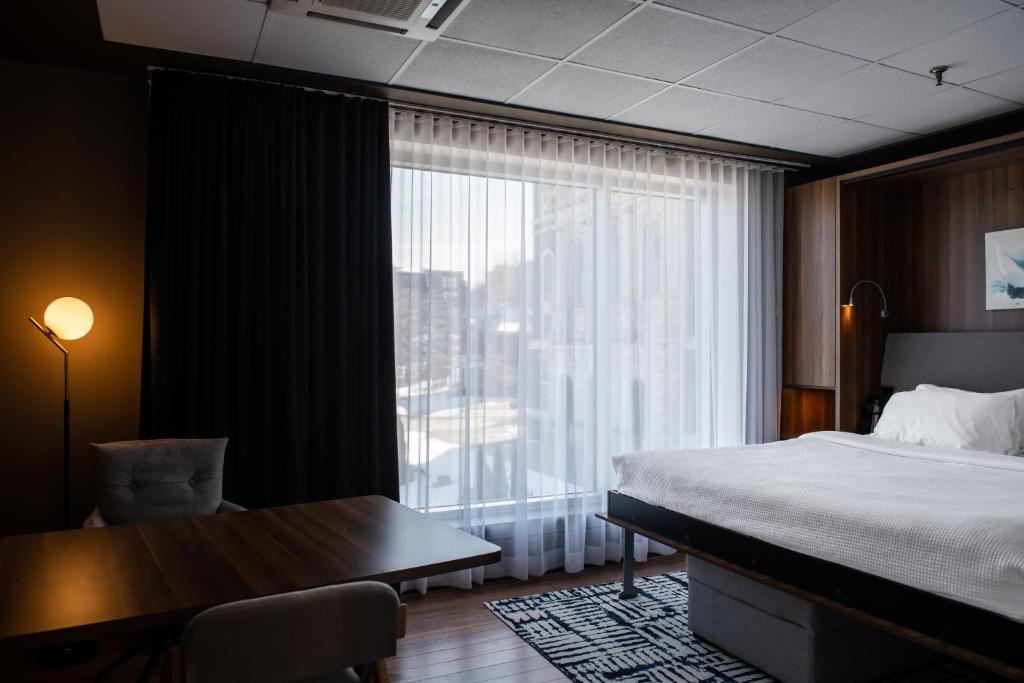 Postel nebo postele na pokoji v ubytování Hotel Chicoutimi, affilié à Hyvi