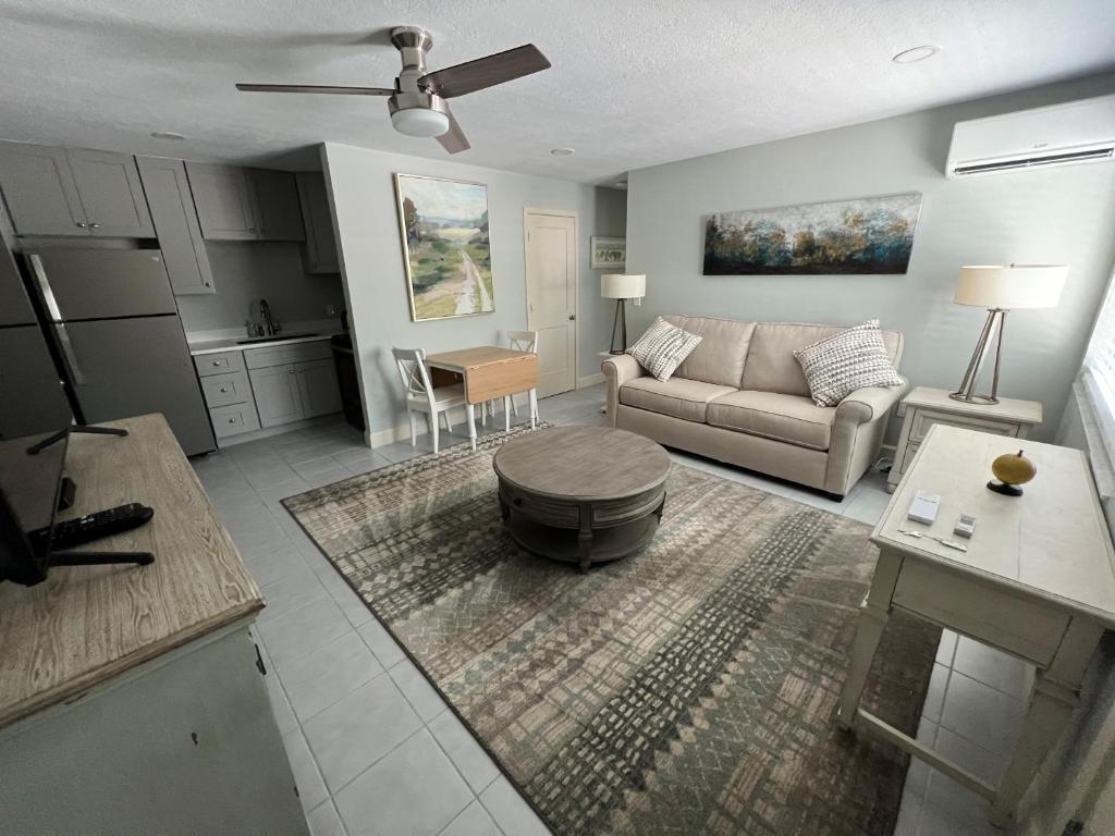 a living room with a couch and a table at Tarpon Tale Inn in Sanibel