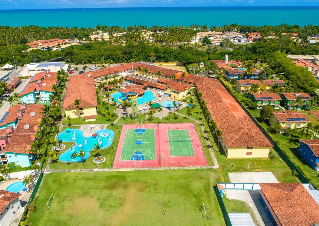 uma vista aérea de uma grande propriedade com piscina e resort em Apartamento Porto Bello Park by Decolando Turismo em Porto Seguro