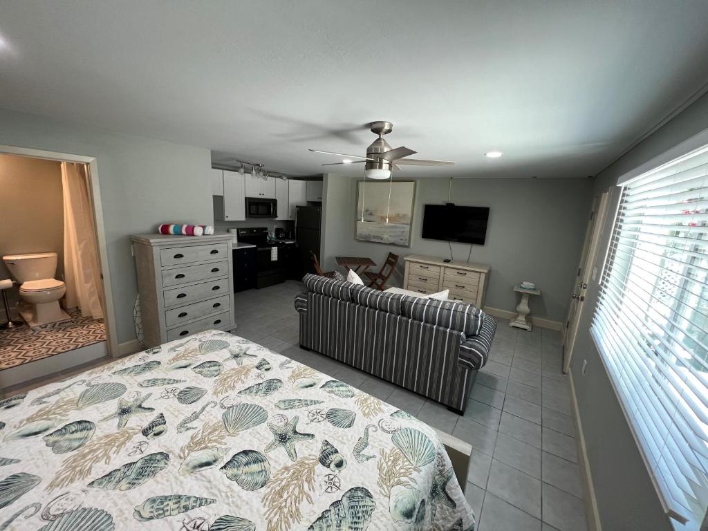 a bedroom with a bed and a couch and a television at Tarpon Tale Inn in Sanibel