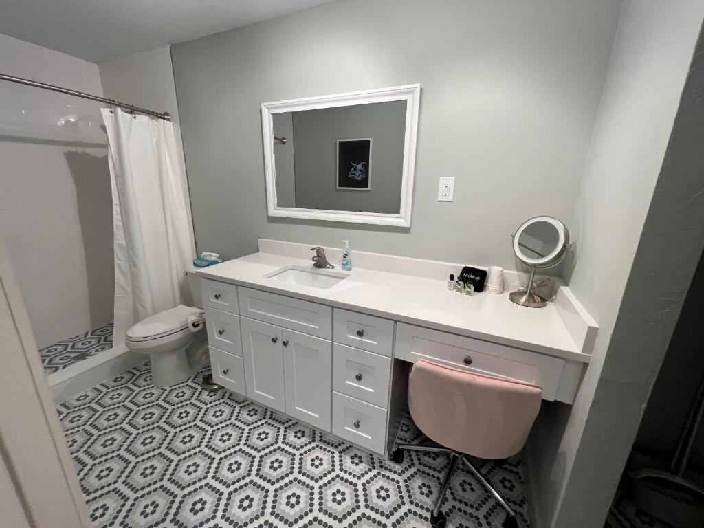 a bathroom with a sink and a toilet and a mirror at Tarpon Tale Inn in Sanibel
