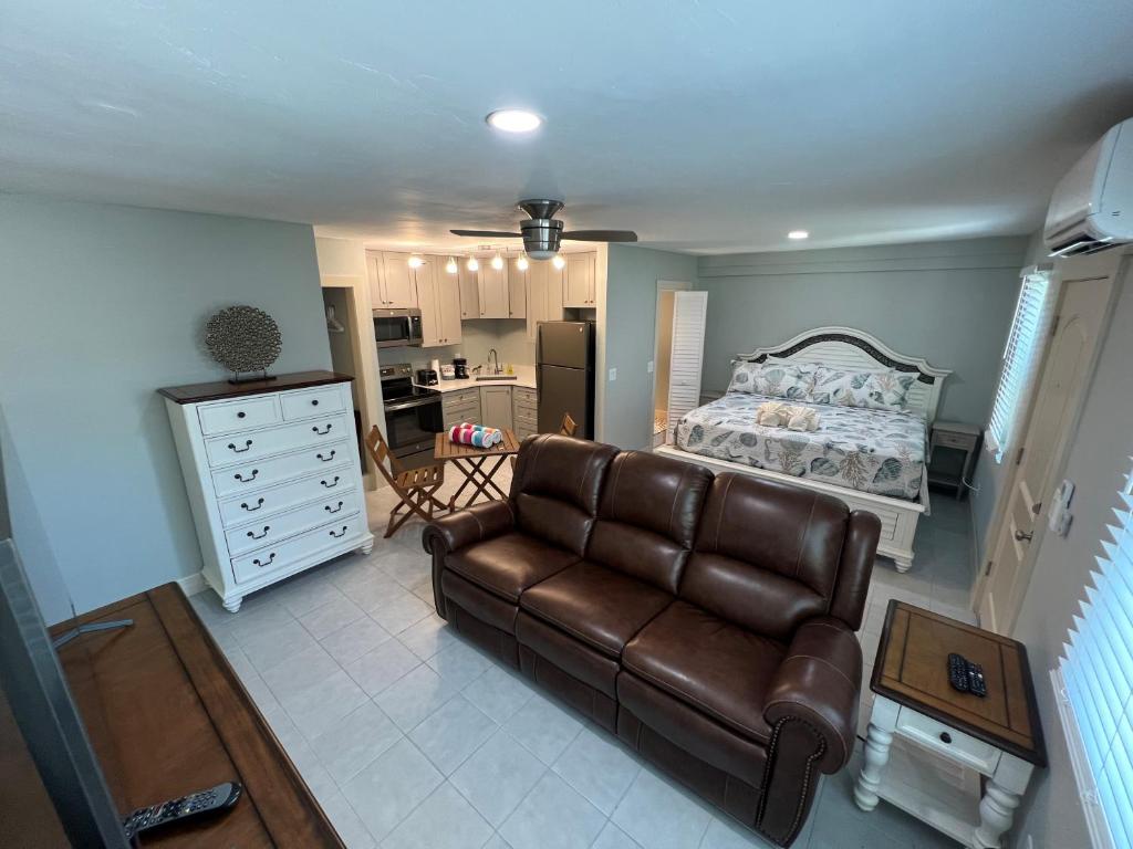 a living room with a couch and a bed at Tarpon Tale Inn in Sanibel