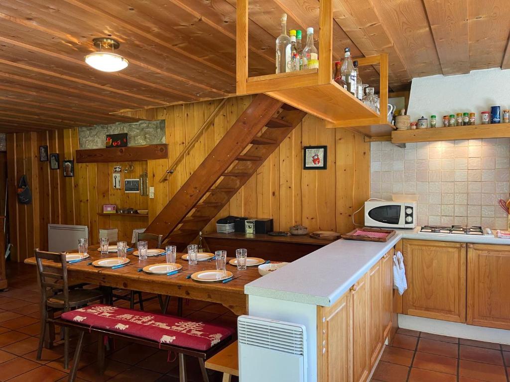 a kitchen with a large wooden table with chairs at Chalet Samoëns, 5 pièces, 8 personnes - FR-1-624-134 in Samoëns