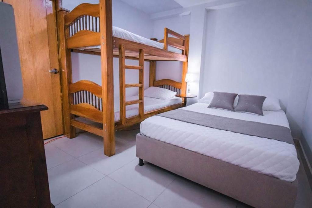a bedroom with two bunk beds and a television at CASA SANTA CIRCASIA in Circasia