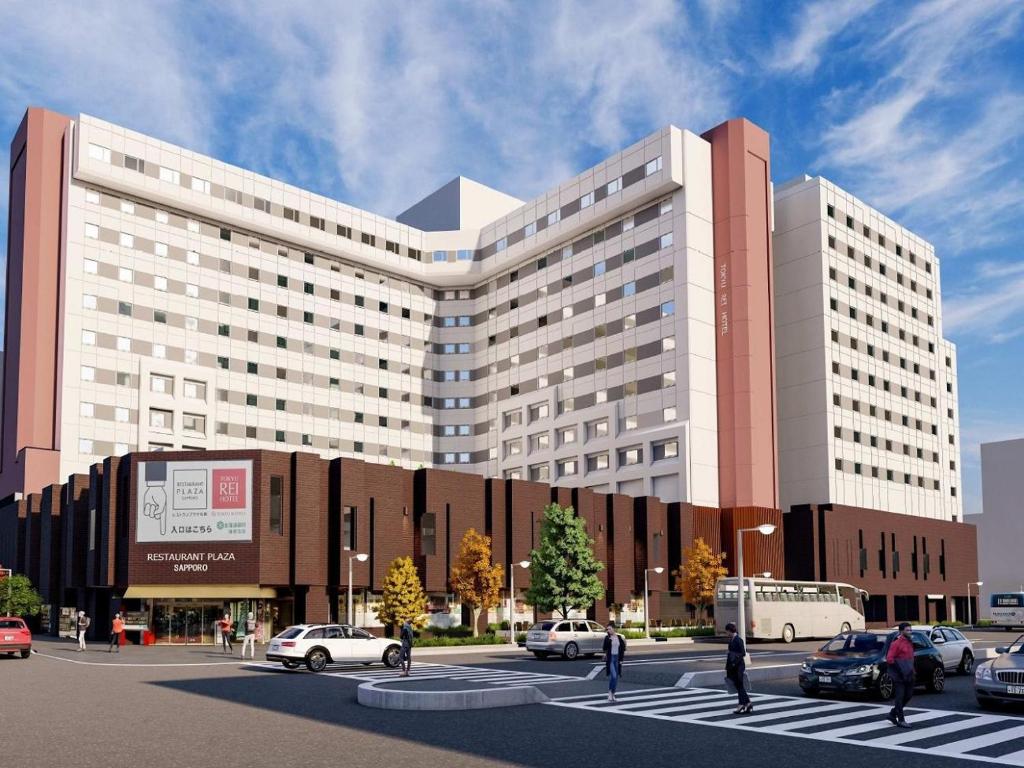 a large building with cars parked in a parking lot at Sapporo Tokyu REI Hotel in Sapporo