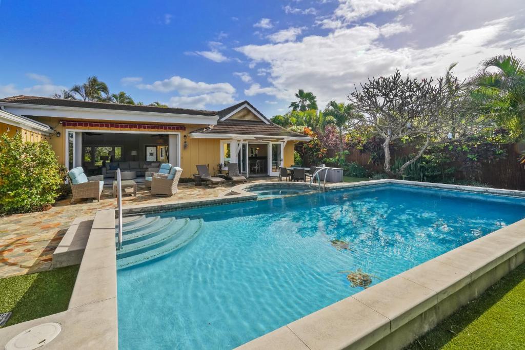 a swimming pool in the backyard of a house at Poipu Kai 3 Bedroom with Pool and Spa- Alekona Kauai in Koloa