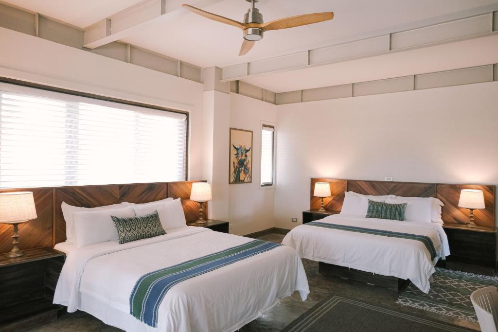 Postel nebo postele na pokoji v ubytování Kaimana Resort Siargao