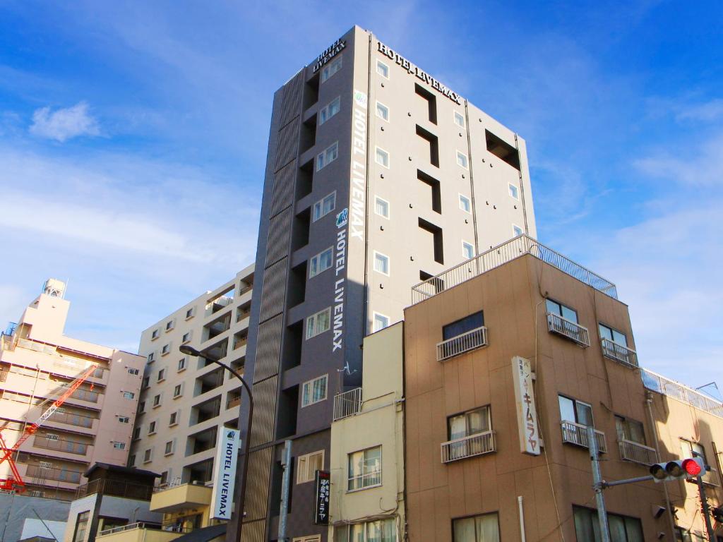 a tall building on the side of a street at HOTEL LiVEMAX Asakusa Sky Front in Tokyo