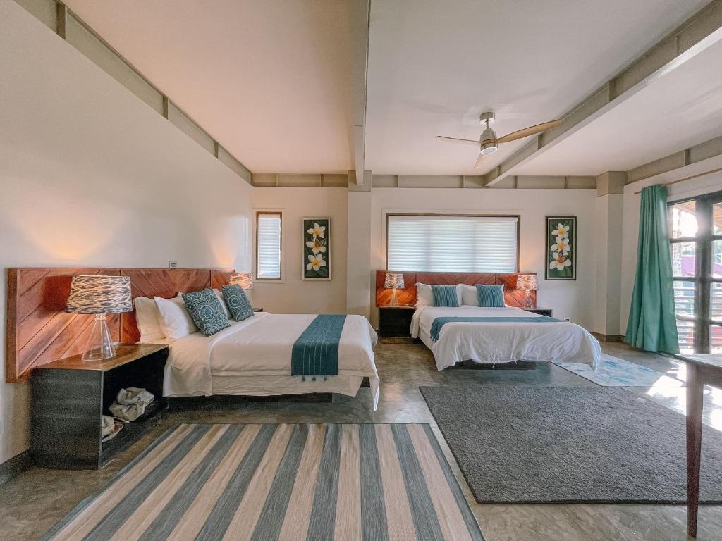 Postel nebo postele na pokoji v ubytování Kaimana Resort Siargao