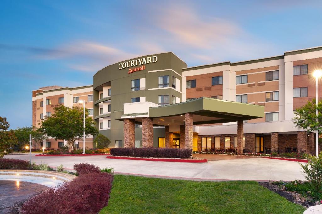 a rendering of a hotel with a building at Courtyard by Marriott Houston NASA Clear Lake in Nassau Bay