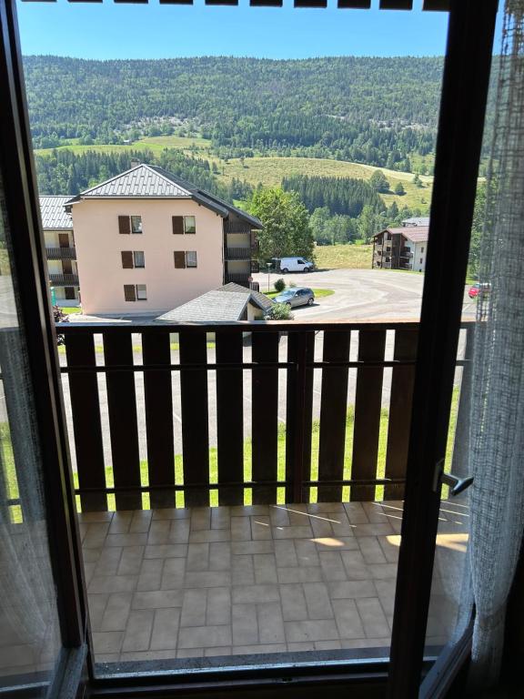 a view from the balcony of a house at Superbe appartement tout équiper in Lélex