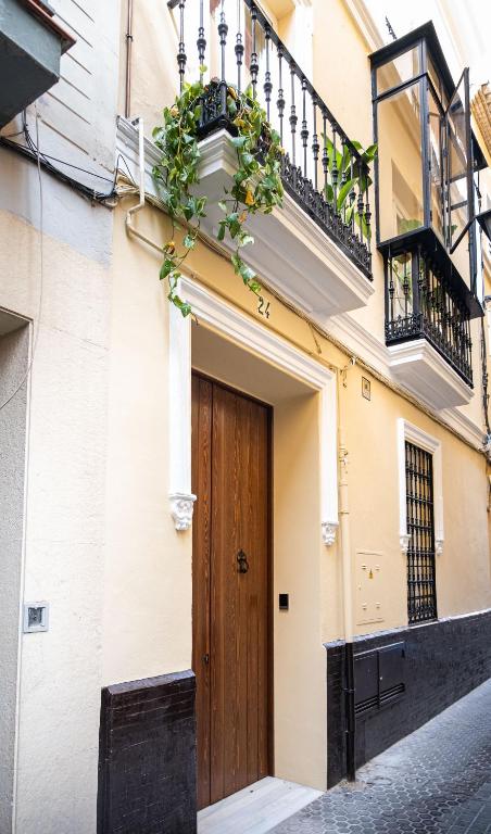 a building with a wooden door on a street at EME SEVILLA TURISTICA in Seville