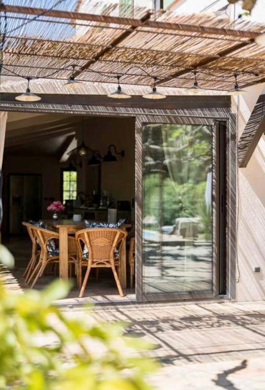 une véranda avec une table et des chaises dans l'établissement Maison de vacances à Cassis, à Cassis