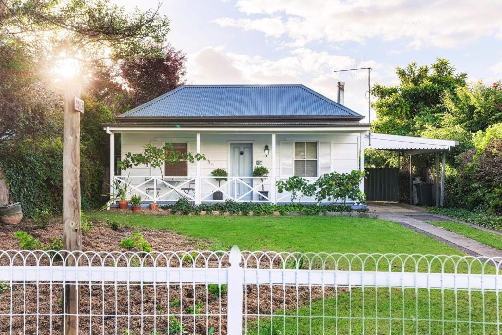 a white house with a white picket fence at Home Away From Home Little White Cottage Mudgee in Mudgee
