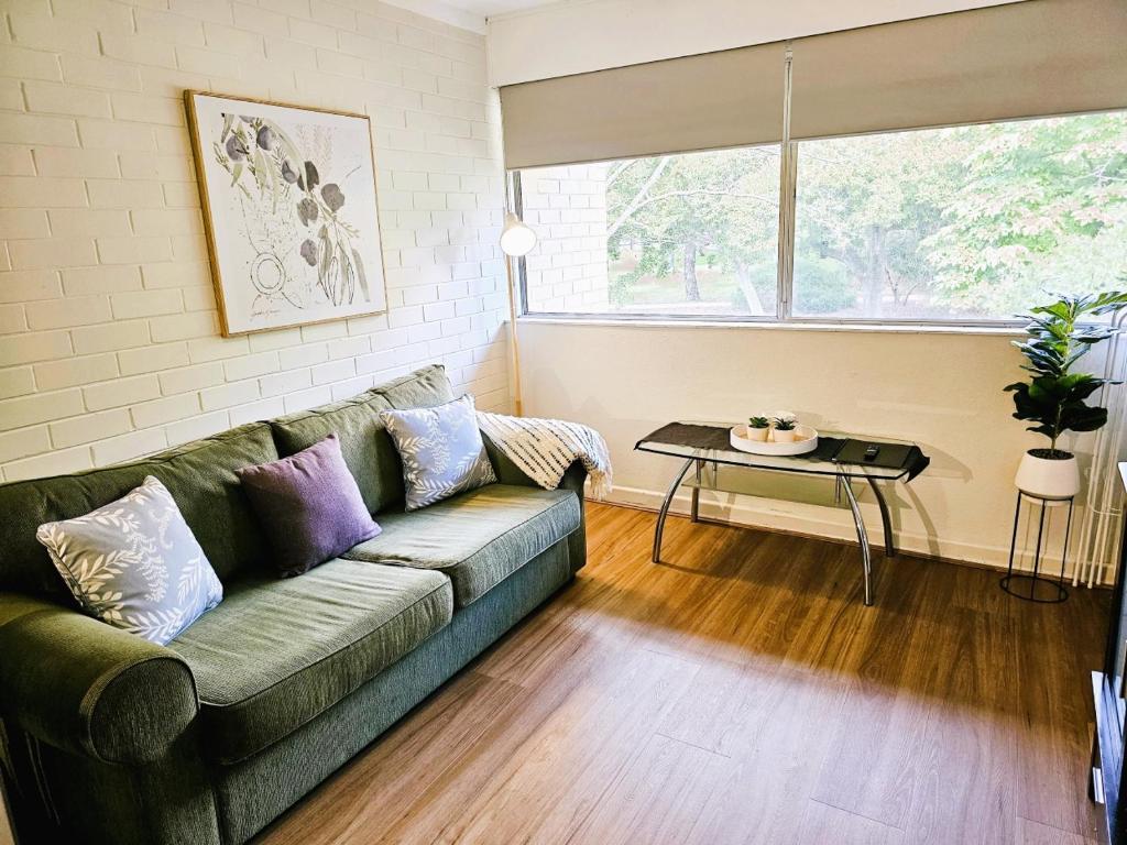 a living room with a couch and a table at The Parks Rosalie 32 - 1BRM Unit with Parking in Perth