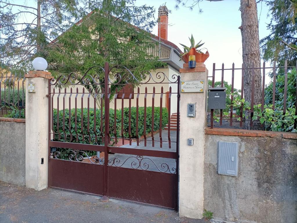 una cerca con una puerta con un árbol detrás de ella en CASA VACANZE FRANCESCO E TANINA, en Nicolosi