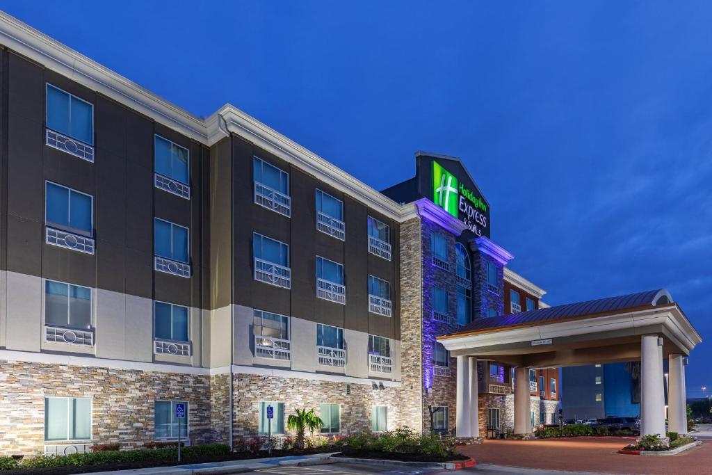 una imagen de un edificio de hotel con un letrero iluminado en Holiday Inn Express Houston Space Center-Clear Lake, an IHG Hotel, en Webster