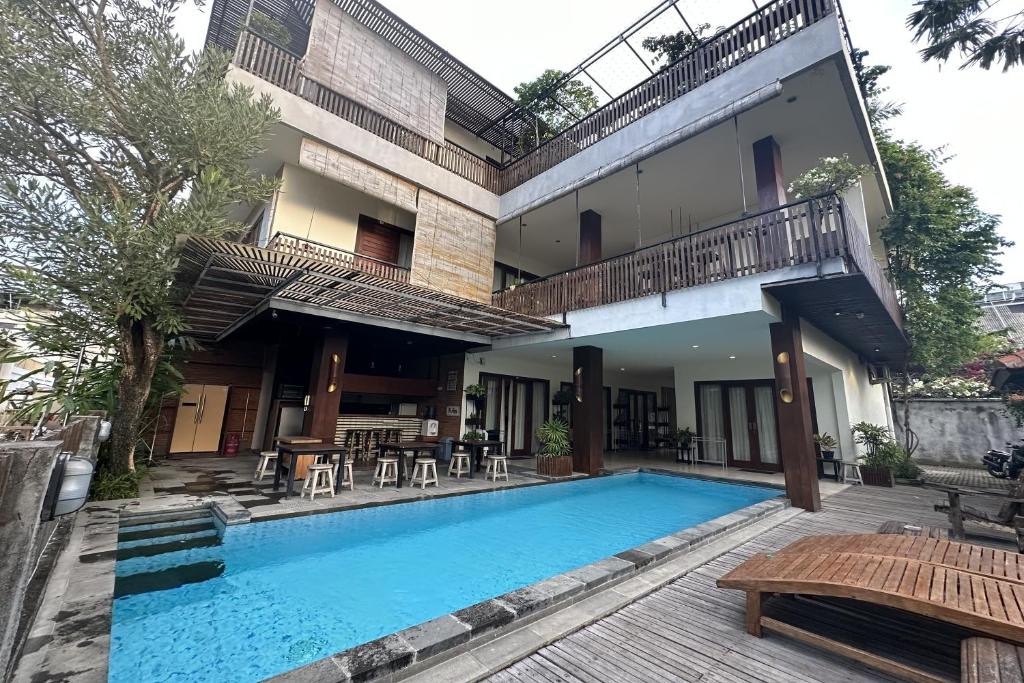 a villa with a swimming pool and a building at The Paving Villa in Canggu