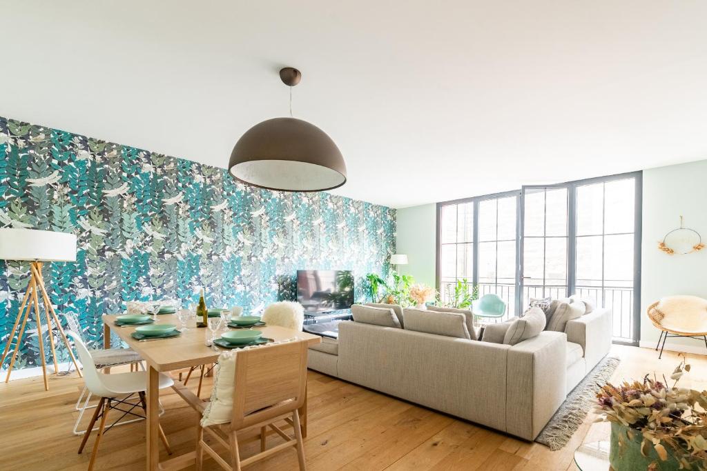 un salon avec un canapé et une table dans l'établissement LE BOSTON - Hypercentre - 150 M 2- 7 Guest, à Dijon