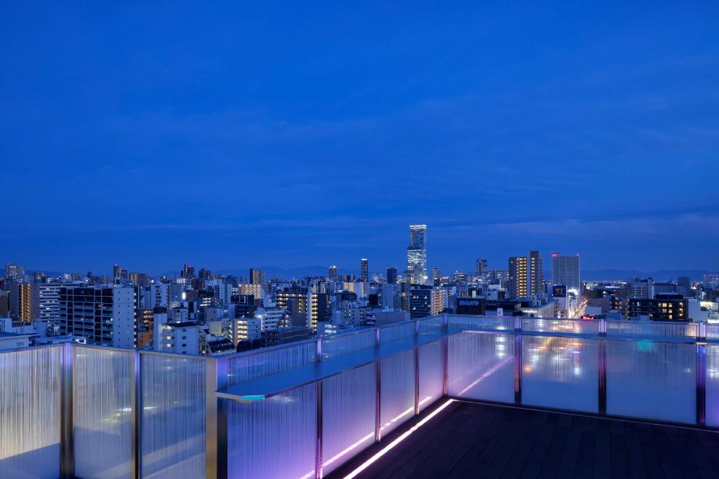 a view of a city skyline at night at the b namba-kuromon in Osaka