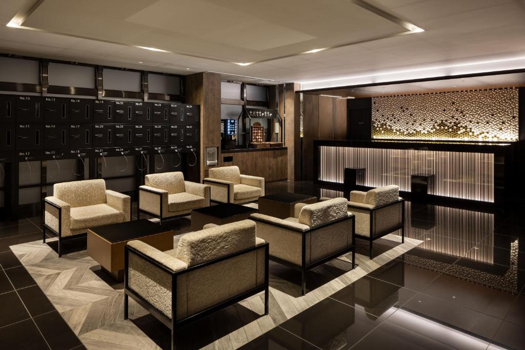 a bar with chairs and tables in a room at the b namba-kuromon in Osaka