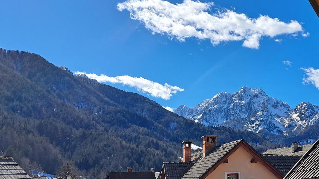 a view of a mountain range with houses and mountains at Hiša Grilc in Kranjska Gora