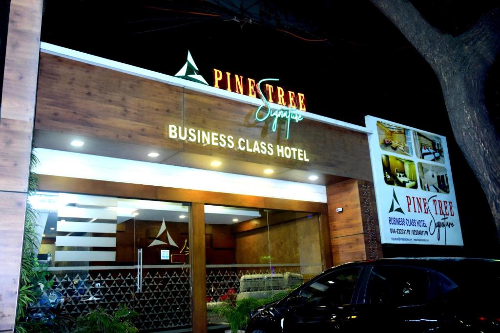 a business sign on the front of a building at Pine Tree Signature in Chennai