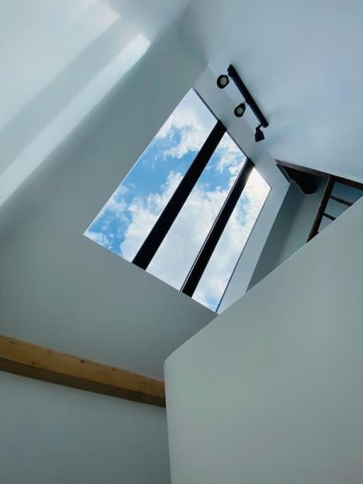 a window in the ceiling of a room with the sky at Joli Duplex à quelques pas du centre de Bayonne in Bayonne