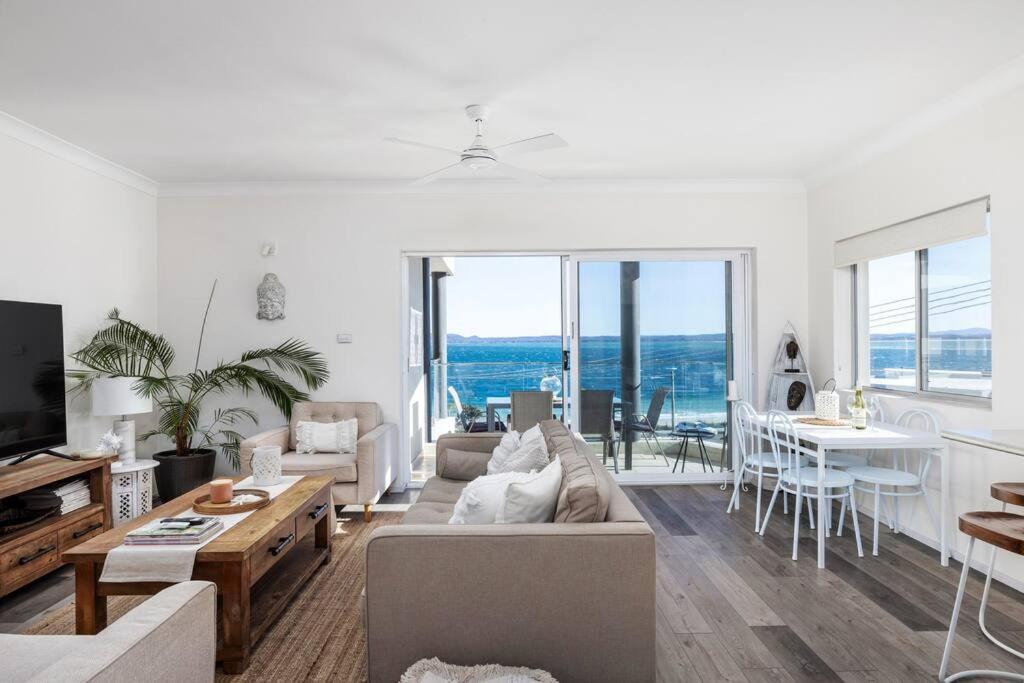 a living room with a couch and a table at Bayview Towers 10 in Nelson Bay