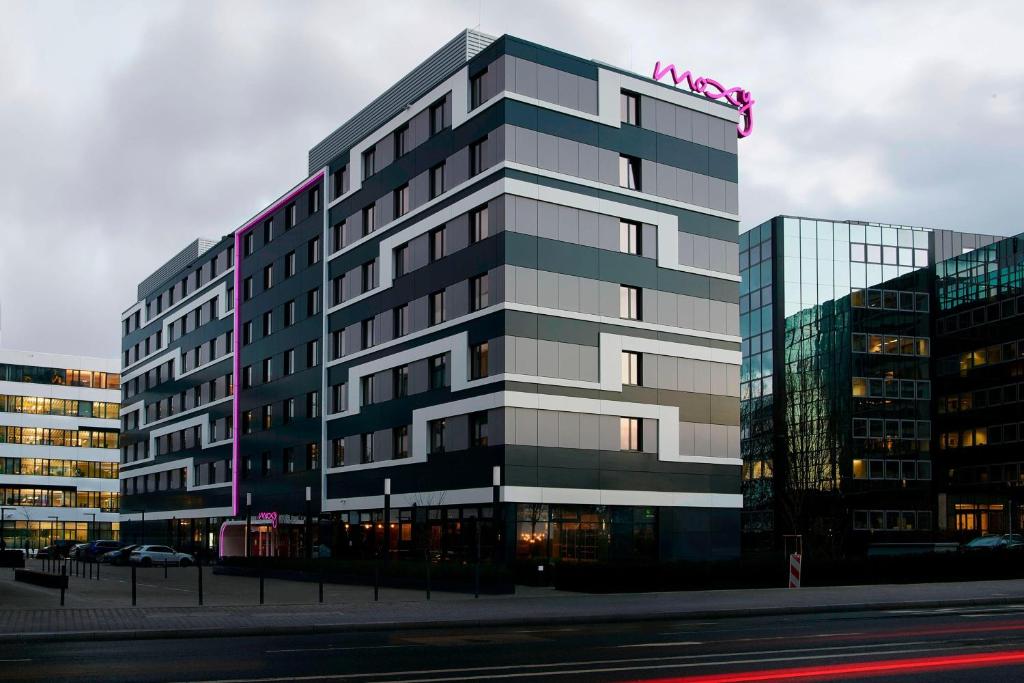 a tall building with a sign on top of it at Moxy Frankfurt Eschborn in Eschborn