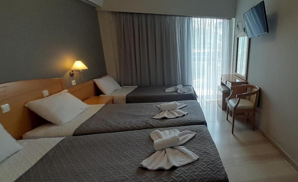 Postel nebo postele na pokoji v ubytování Hotel Serenity Tolo