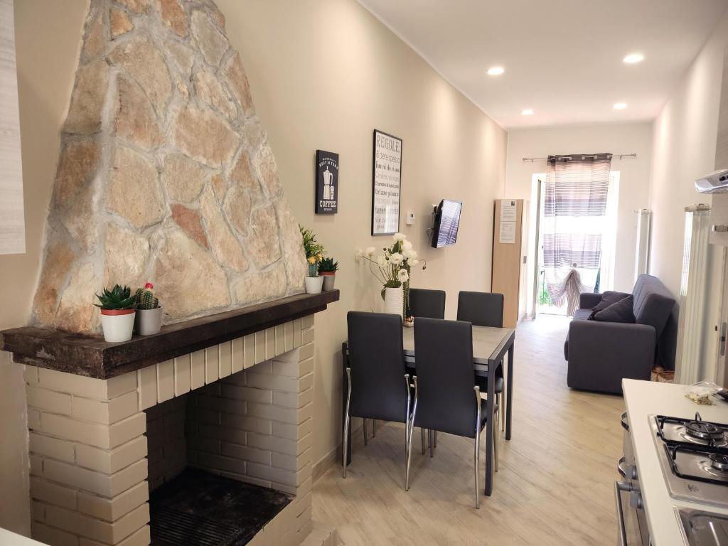 a living room with a fireplace and a table and chairs at La Torre in Tarquinia