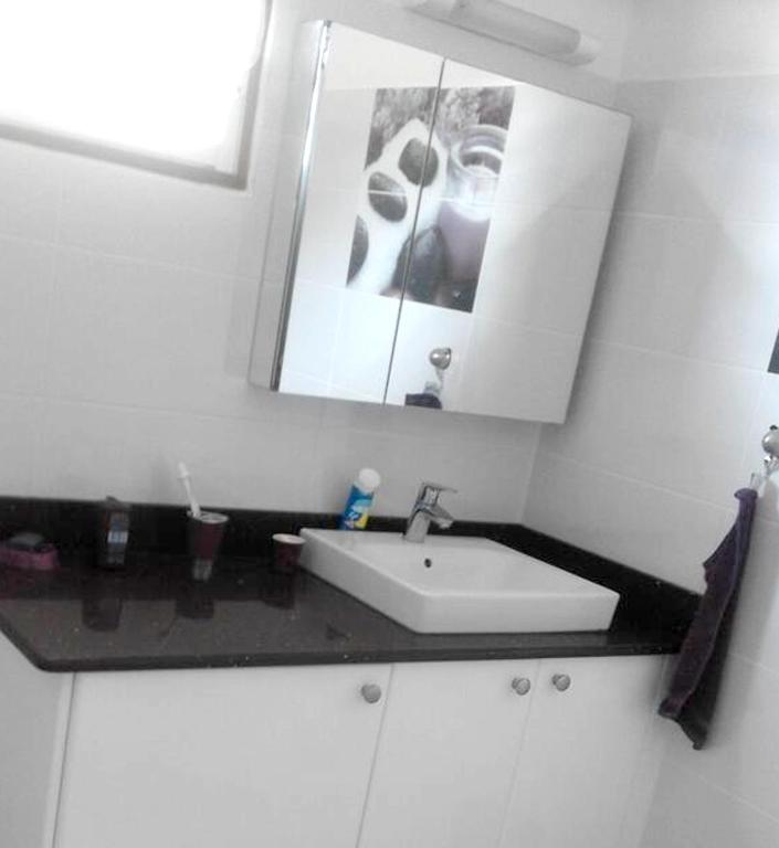 a white bathroom with a sink and a mirror at Maison de 2 chambres avec vue sur la mer jardin amenage et wifi a Vieux Habitants a 2 km de la plage in Vieux-Habitants