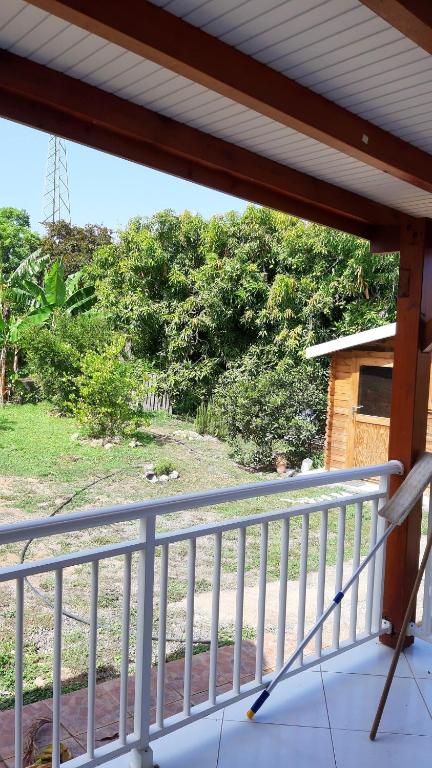 a balcony with a view of a yard at Maison de 2 chambres avec vue sur la mer jardin amenage et wifi a Vieux Habitants a 2 km de la plage in Vieux-Habitants