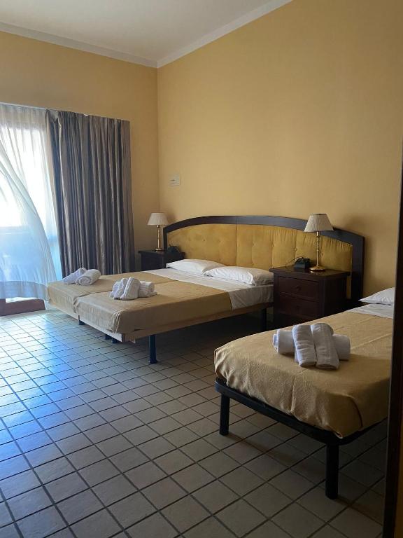 Postel nebo postele na pokoji v ubytování Albergo Etico Cesenatico