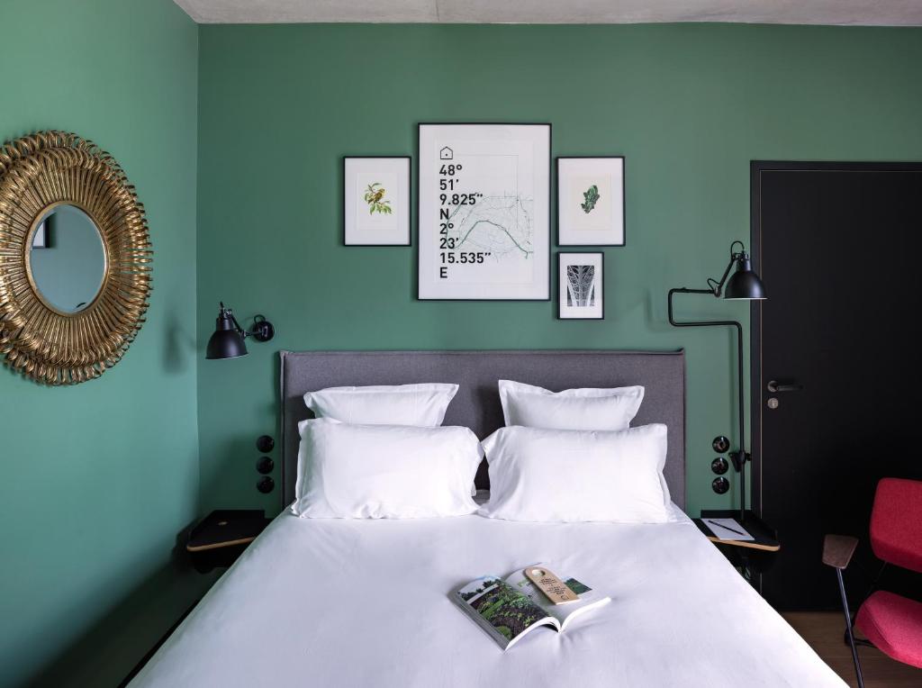 a bedroom with a bed with a book on it at Deskopolitan House in Paris