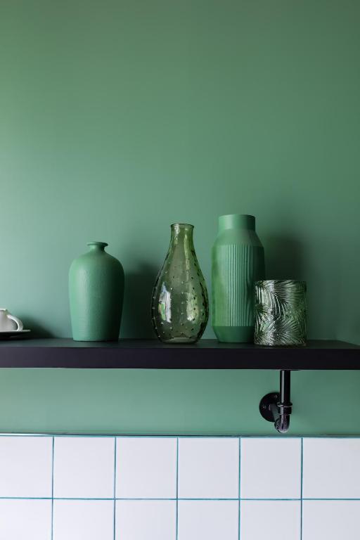 a shelf with three vases sitting on it at Deskopolitan House in Paris