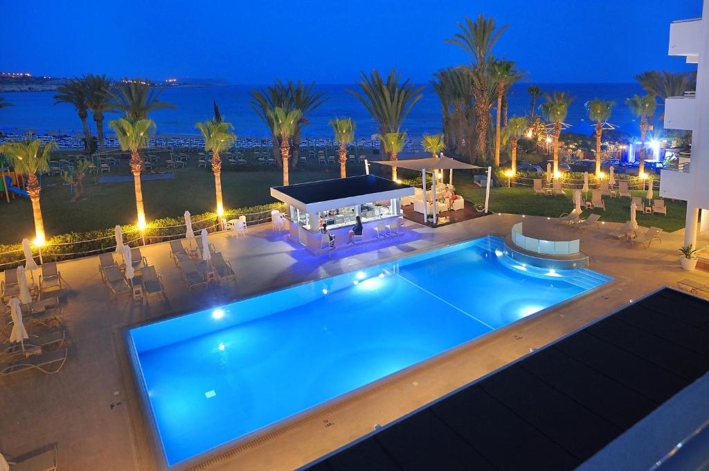 an overhead view of a swimming pool at night at Okeanos Beach Boutique Hotel in Ayia Napa
