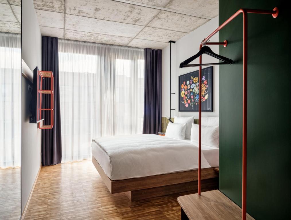 um quarto com uma cama e uma parede verde em URBAN LOFT Berlin em Berlim