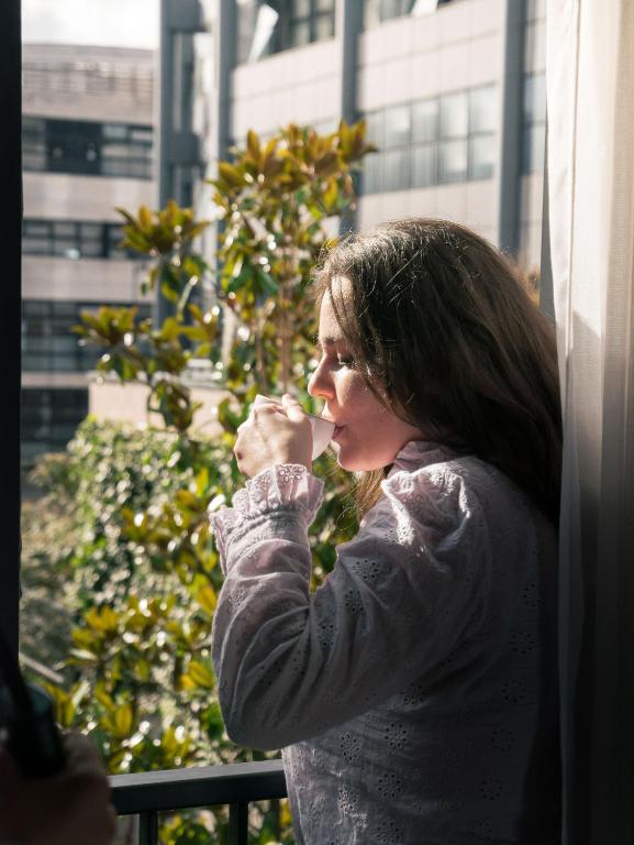 a woman looking out of a window at Deskopolitan House in Paris