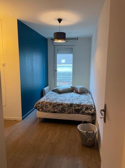 a bedroom with a bed in a room with a window at Saint-Denis Basilique : centre historique in Saint-Denis