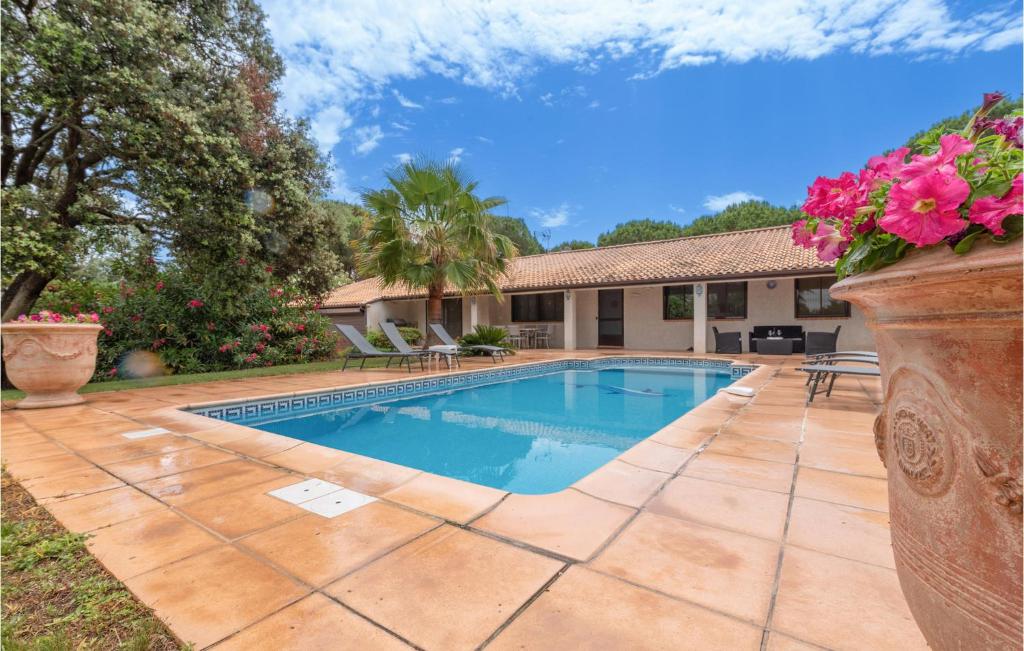 a swimming pool in the backyard of a house at Lovely Home In Vias With Outdoor Swimming Pool in Vias