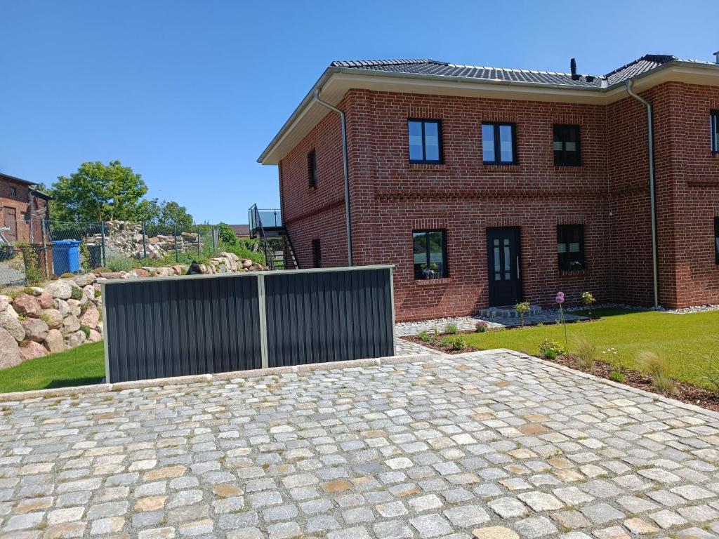 a brick house with a gate in front of it at Ferienwohnung Jonte in Sassnitz