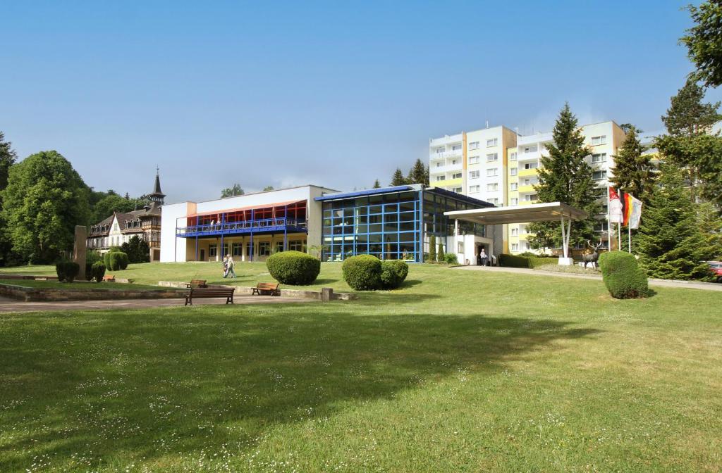a large building with a park in front of it at Morada Hotel Alexisbad in Alexisbad
